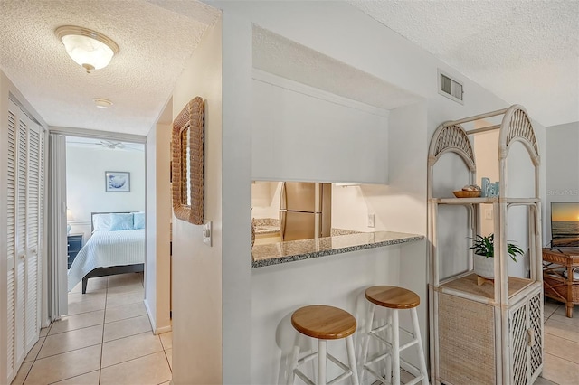 6157 Midnight Pass Rd Unit G11, Sarasota, FL 34242 - hallway featuring a textured ceiling and light tile patterned floors