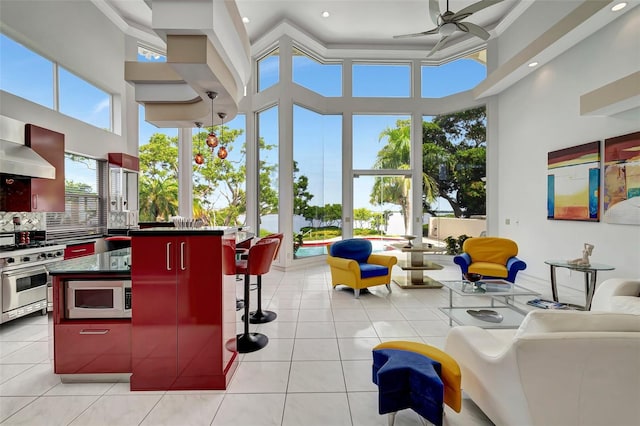 interior space with ceiling fan and a high ceiling