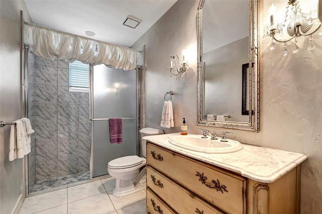 bathroom with vanity, walk in shower, tile patterned flooring, and toilet