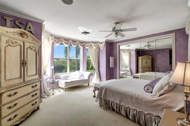 carpeted bedroom featuring crown molding and ceiling fan