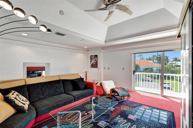 carpeted living room featuring ceiling fan, crown molding, and a tray ceiling