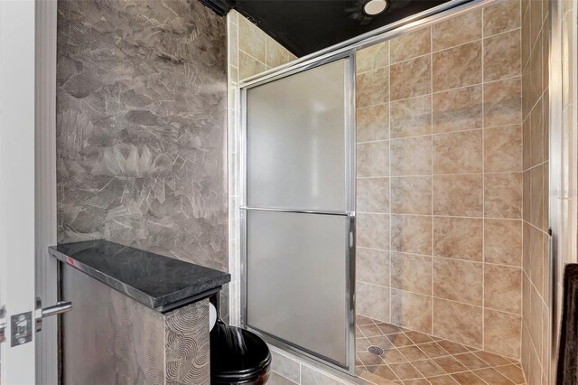 bathroom with a shower with door