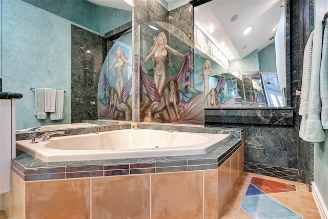 bathroom with a relaxing tiled tub, lofted ceiling, and tile patterned flooring