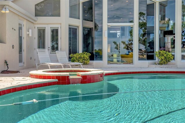 view of pool with an in ground hot tub