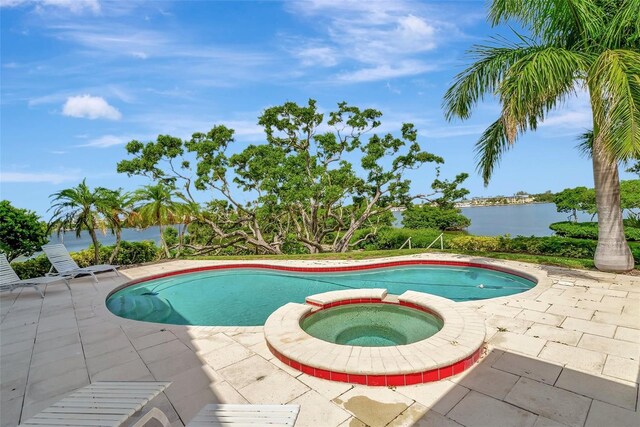 view of pool featuring an in ground hot tub and a patio