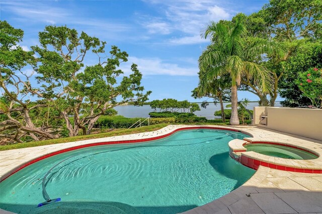 view of swimming pool with an in ground hot tub