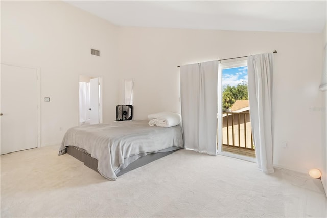 bedroom featuring lofted ceiling, access to exterior, and carpet flooring