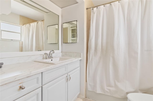 bathroom featuring shower / tub combo with curtain and vanity