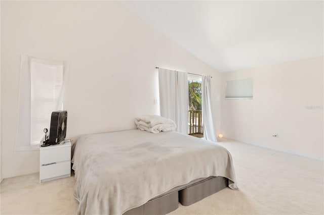 bedroom featuring lofted ceiling, access to outside, and light colored carpet