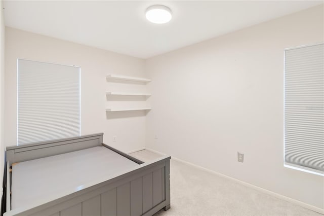 unfurnished bedroom with light colored carpet