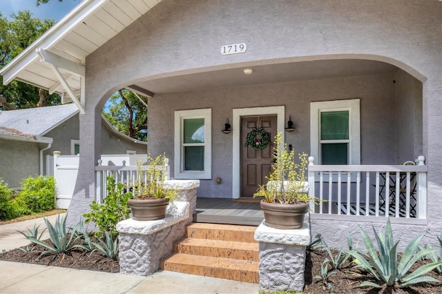 view of exterior entry featuring a porch