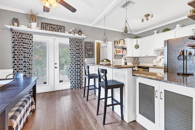 kitchen featuring french doors, stainless steel fridge, decorative light fixtures, white cabinets, and dark hardwood / wood-style floors