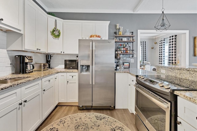 kitchen with backsplash, white cabinetry, stainless steel appliances, and decorative light fixtures