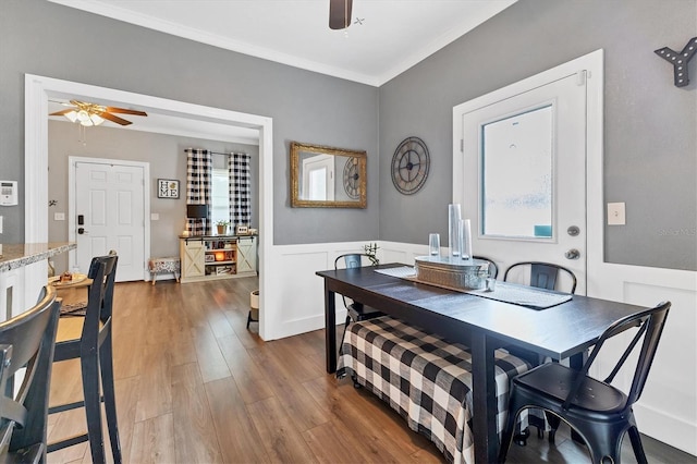 dining space featuring ceiling fan, dark hardwood / wood-style floors, and ornamental molding