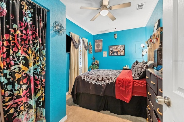 bedroom with carpet, ceiling fan, and crown molding