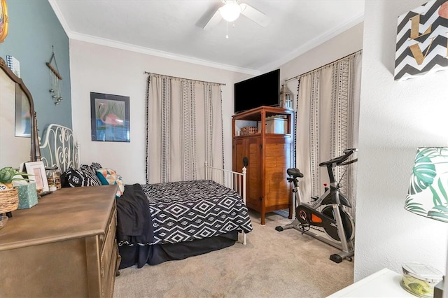 carpeted bedroom featuring ceiling fan and crown molding