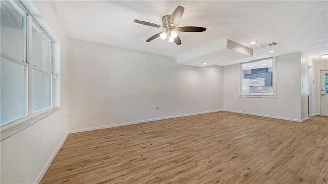 unfurnished room with light hardwood / wood-style flooring and ceiling fan