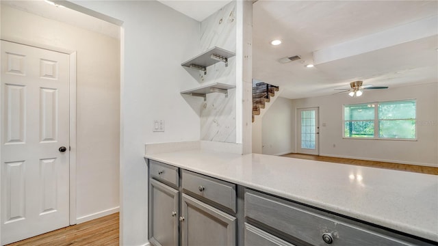 kitchen featuring ceiling fan, gray cabinets, and light hardwood / wood-style floors