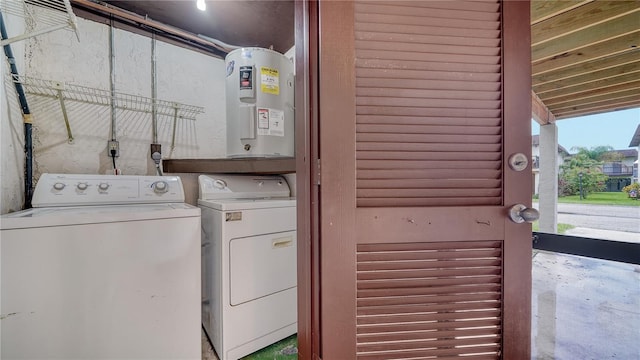 clothes washing area with washing machine and dryer and electric water heater