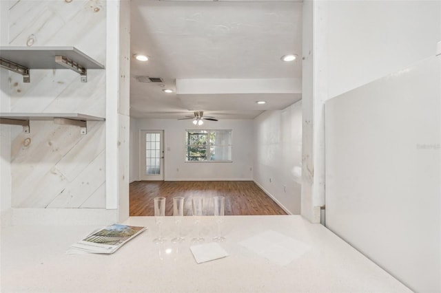 unfurnished living room with hardwood / wood-style flooring and ceiling fan