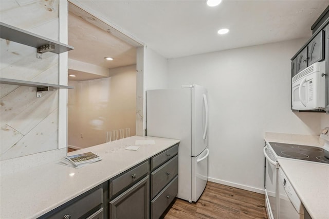 kitchen featuring dark hardwood / wood-style flooring and white appliances