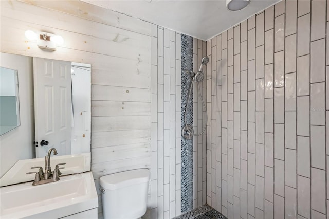 bathroom featuring vanity, toilet, and tiled shower