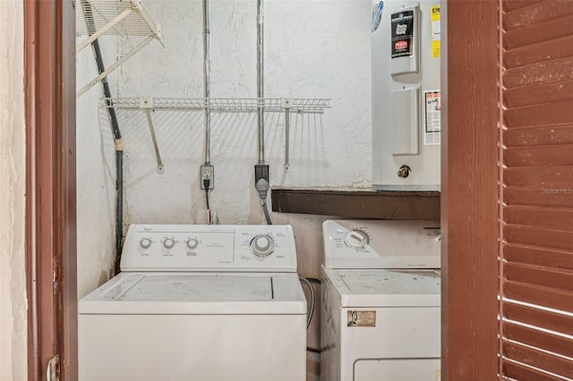 clothes washing area with electric water heater and washing machine and clothes dryer