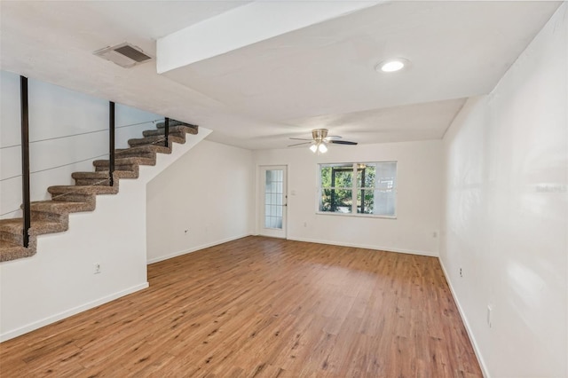 unfurnished living room with ceiling fan and hardwood / wood-style floors