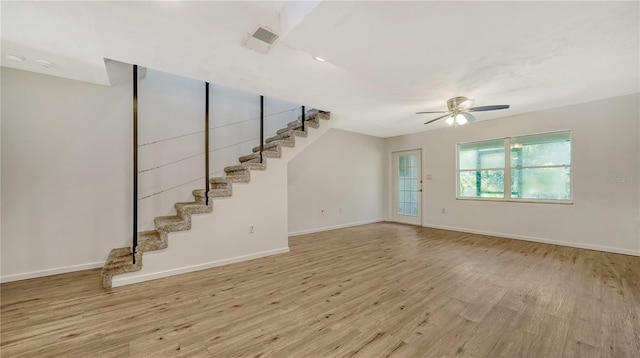 unfurnished living room with light hardwood / wood-style floors and ceiling fan