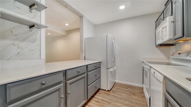 kitchen with white appliances and gray cabinetry