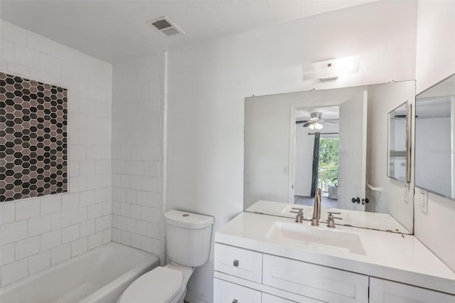 full bathroom featuring tiled shower / bath combo, vanity, ceiling fan, and toilet