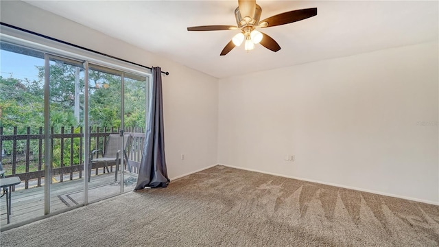 unfurnished room with ceiling fan and carpet