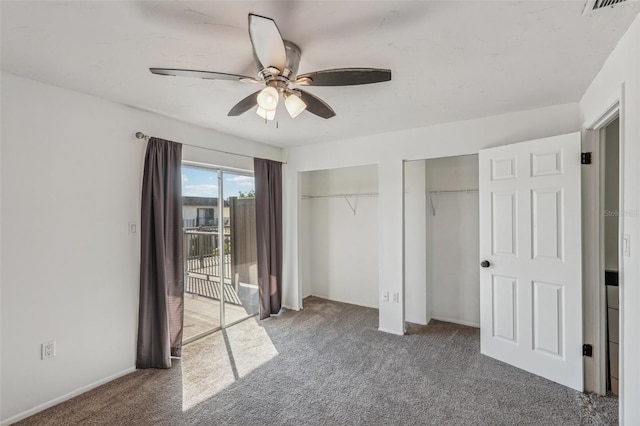 unfurnished bedroom with access to exterior, two closets, carpet floors, and ceiling fan