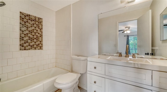 full bathroom with vanity, ceiling fan, tiled shower / bath, and toilet