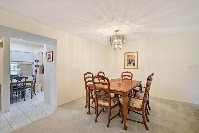 dining room featuring an inviting chandelier and light tile patterned flooring