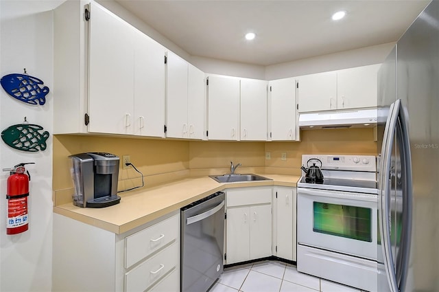 kitchen with white cabinetry, sink, light tile patterned floors, and appliances with stainless steel finishes