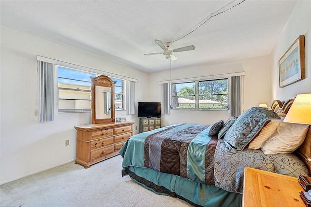 bedroom featuring ceiling fan and light colored carpet