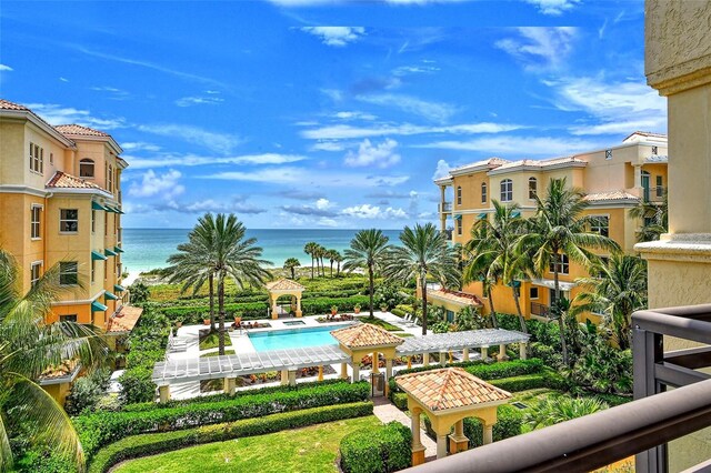 view of swimming pool featuring a water view and a patio area