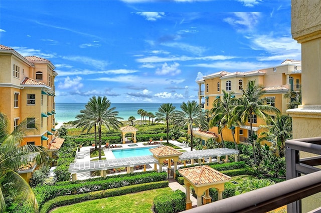 view of swimming pool with a water view and a pergola