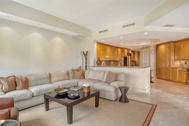 living room with sink and light tile patterned flooring