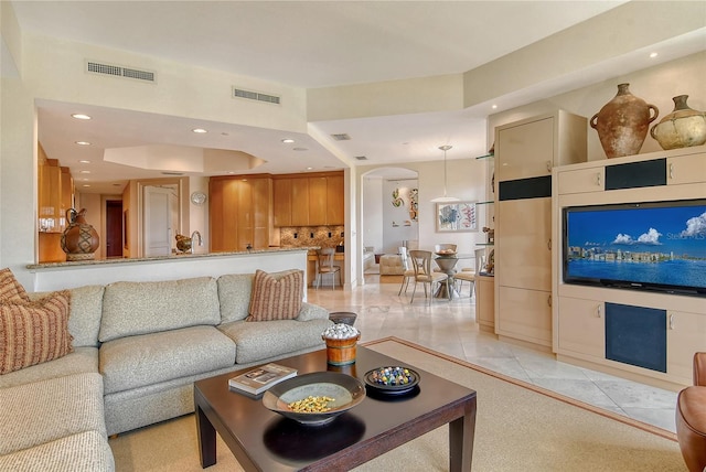 tiled living room with a raised ceiling