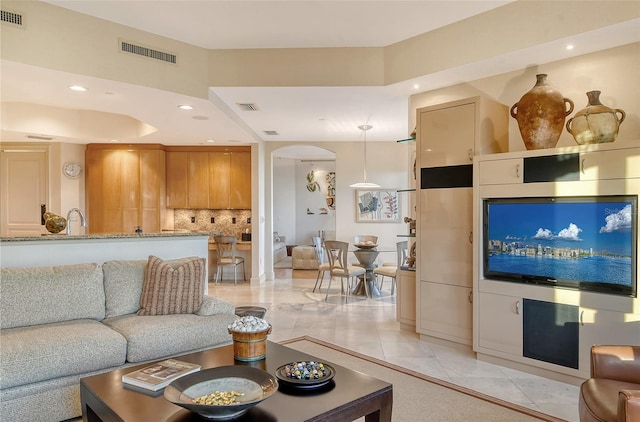 living room with sink and light tile patterned floors