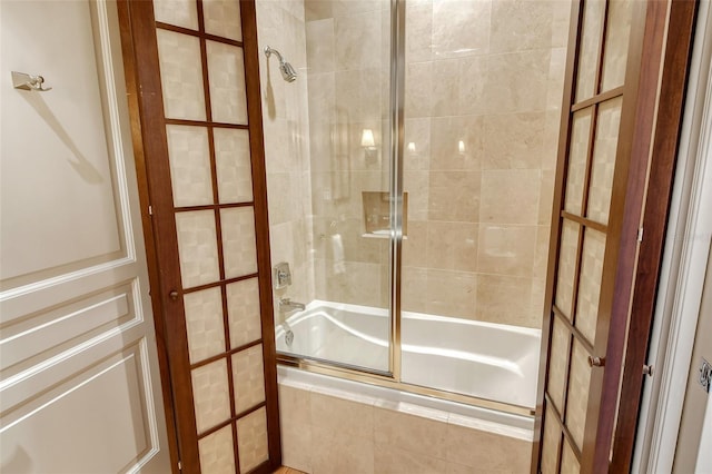 bathroom featuring shower / bath combination with glass door