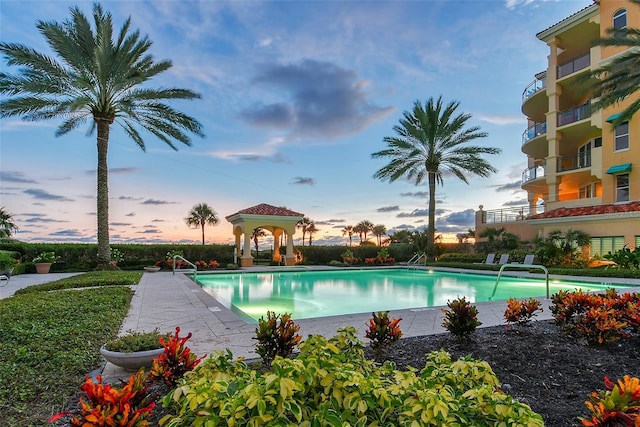 pool at dusk with a gazebo