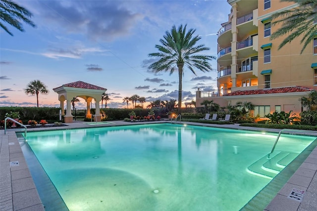 view of pool at dusk