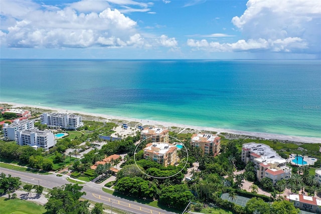 birds eye view of property with a beach view and a water view