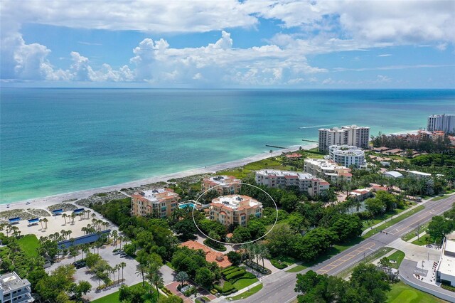 aerial view with a water view and a view of the beach