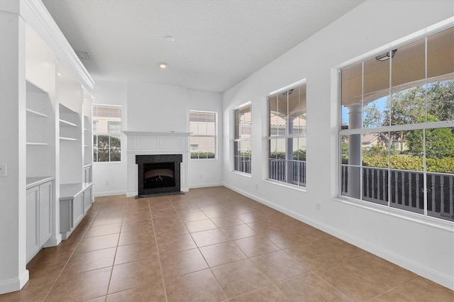 unfurnished living room with a fireplace and light tile patterned floors