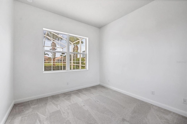 spare room with light colored carpet