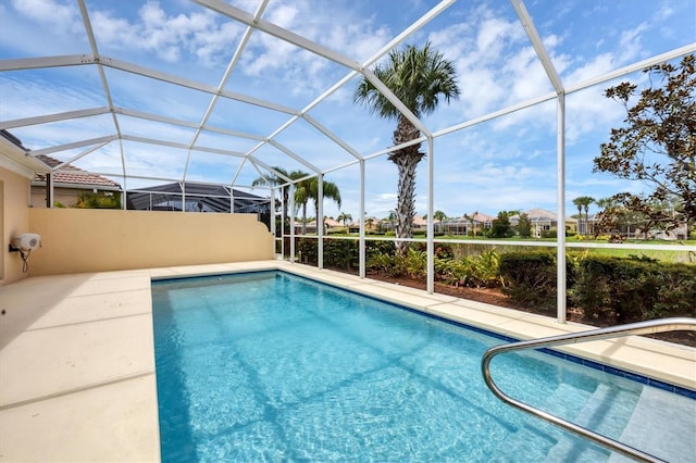 view of swimming pool featuring a lanai